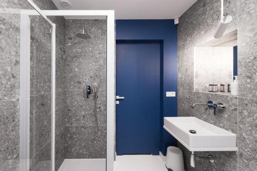 a bathroom with a shower, sink, and toilet at Colors Apartments in Zator