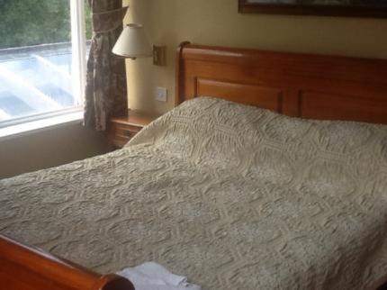 a bedroom with a white bed and a window at The oaklands hotel in Weaverham