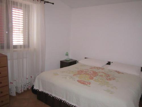 a white bedroom with a bed and a window at Agriturismo Laire Masseria in Alberobello