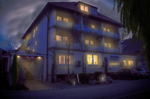 a large house with its lights on at night at Hotel Alpenrose in Bad Wörishofen