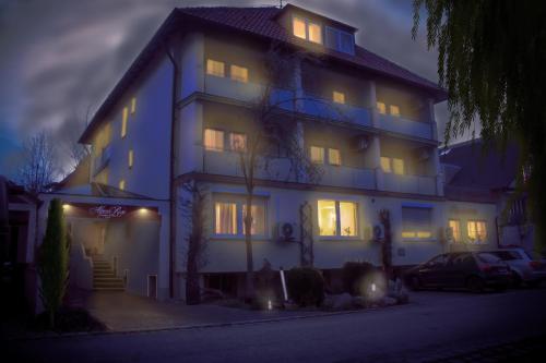 a large house with its lights on at night at Wohlfühlhotel Alpenrose in Bad Wörishofen