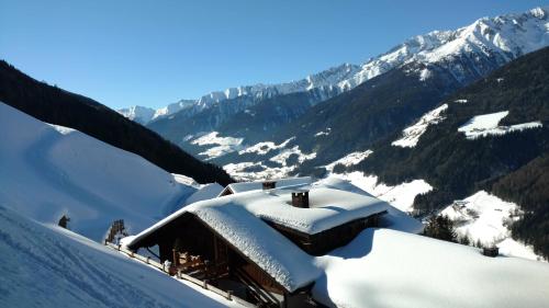 a building covered in snow on top of a mountain at Innertrein in Cadipietra