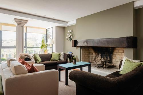 a living room with couches and a fireplace at Hotel D. Luis - Elvas in Elvas