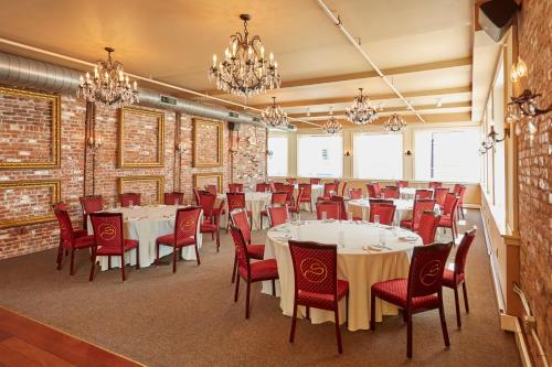 a conference room with tables and chairs and chandeliers at Hotel on North in Pittsfield