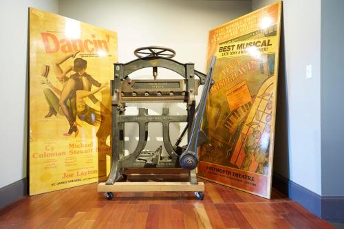 an old machine in front of two movie posters at Hotel on North in Pittsfield