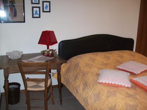 a bedroom with a bed and a table with a lamp at La Bottega Del Falegname in Vanzaghello