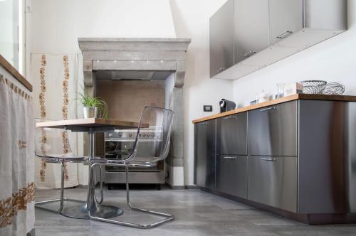 a kitchen with a table and a chair in it at Il Vecchio Comune in Santa Sofia