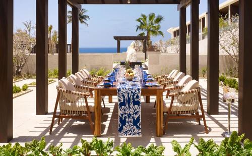 a table with white chairs and a blue and white table cloth at Nobu Hotel Los Cabos in Cabo San Lucas