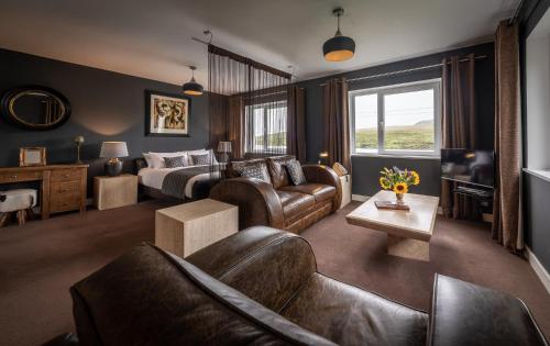 a hotel room with a bed and a living room at Storr Apartments in Portree
