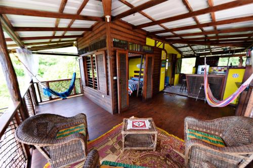 a porch with chairs and a hammock on a house at Windy View Guest House in Providencia