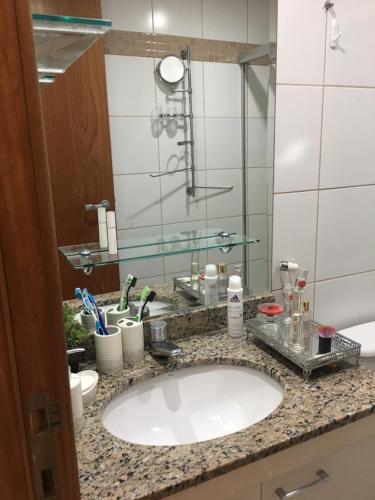 a bathroom counter with a sink and a mirror at Life Resort - Flat Aconchegante in Brasília