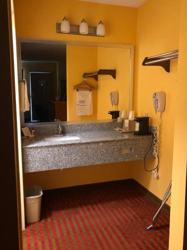 a bathroom with a sink and a mirror at Days Inn by Wyndham Franklin in Franklin