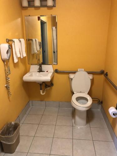 a bathroom with a toilet and a sink at Days Inn by Wyndham Franklin in Franklin