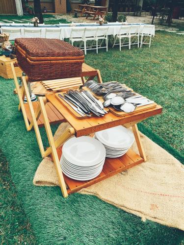 a picnic table with plates and utensils on it at Tobacco Village in Meinong