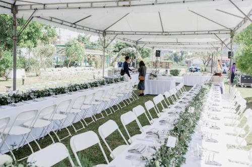 a wedding ceremony with white tables and white chairs at Tobacco Village in Meinong