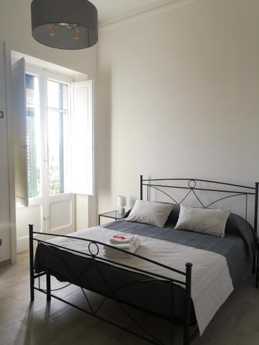 a bedroom with a bed with a black frame at Casa Midori in Lecce