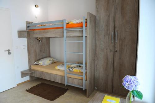 a bunk bed with two bunk beds in a room at Hostel Ormož in Ormoz