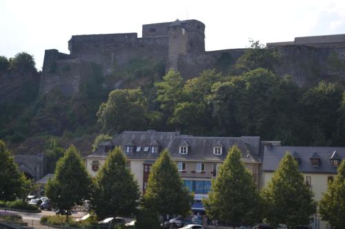 a castle on top of a hill with houses at Maison D'ide in Bouillon