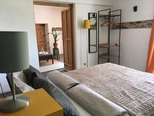 a bedroom with a bed and a table with a lamp at Mountainhome Casa Cancelinha in Soito