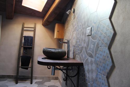 a bathroom with a stone bowl on a stool at Langa 4 Love in Novello