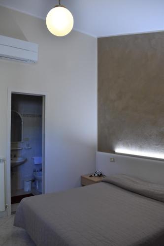 Ένα ή περισσότερα κρεβάτια σε δωμάτιο στο Camere Santa Chiara