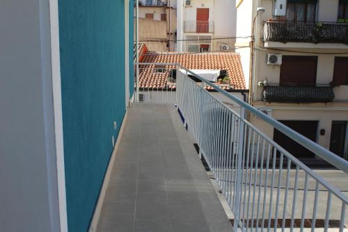 a balcony of a building with a blue wall at Naxos Laguna Beach in Giardini Naxos