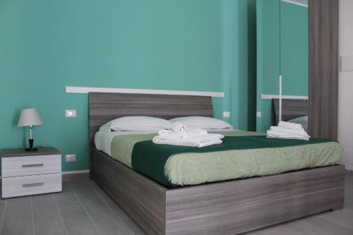 a bedroom with a bed with towels on it at Naxos Laguna Beach in Giardini Naxos