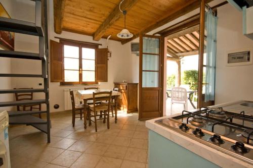 a kitchen with a stove and a table with chairs at Relais Il Ciliegio in Sorano