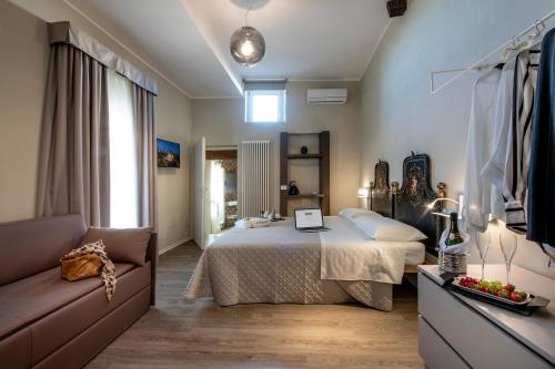 a bedroom with a bed and a couch at RESIDENZA DON ALBERTO in Ornano Grande