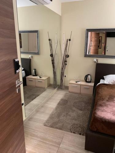 a bedroom with a bed and two sinks and a mirror at Enter Rooms in Zagreb