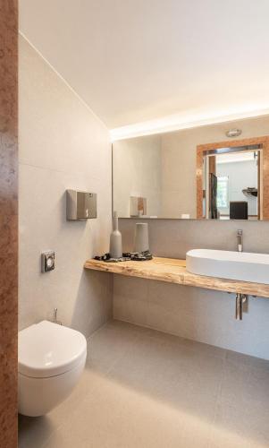 a bathroom with a toilet and a sink and a mirror at Sea Tower Torre Telemetrica Lido di Venezia in Venice-Lido
