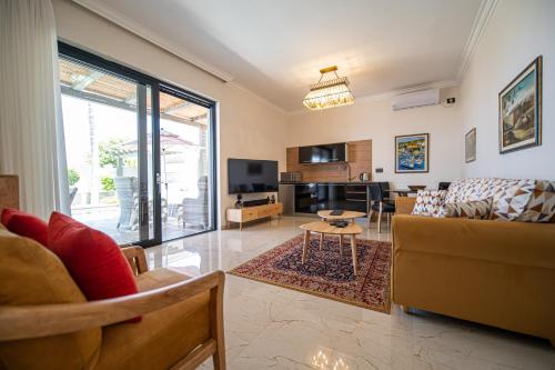 a living room with a couch and a table at sul mare סוויטות in Ashqelon