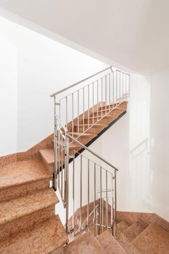 a staircase in a house with a metal railing at Sea Tower Torre Telemetrica Lido di Venezia in Venice-Lido