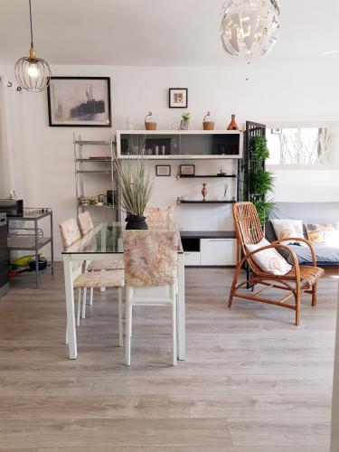 a living room with a glass table and chairs at Lolita's house Alhambra in Seville