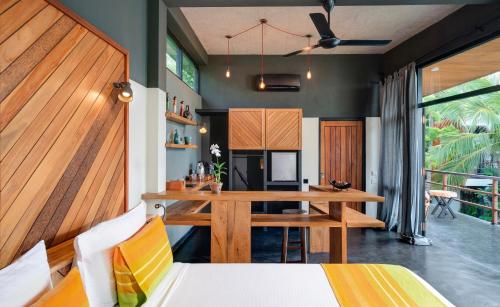 a dining room with a wooden table and a dining room at Lankavatara Ocean Retreat & Spa in Tangalle