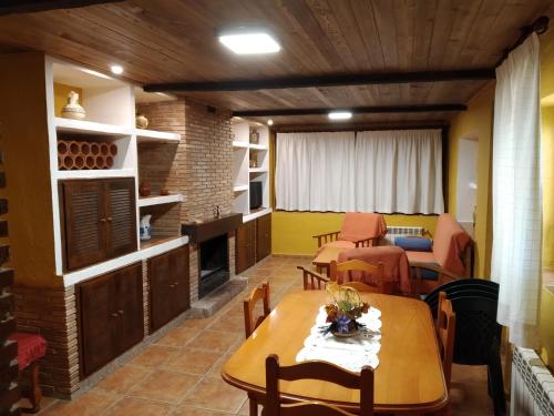 a living room with a table and a fireplace at CASA MARIBEL in Güéjar-Sierra