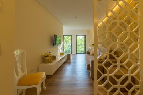 a hallway with a wall with a geometric design at Terrace Serra Hotel in Covilhã