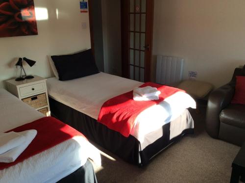 a bedroom with two beds and a couch at The Stag Hotel in Banchory