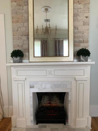 a fireplace with a mirror on top of it at The Kendall in Boerne