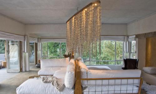 a living room with a couch and a chandelier at Qambathi Mountain Lodge in Kamberg Valley