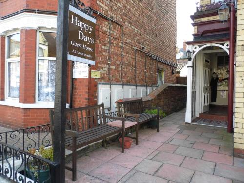 a couple of benches sitting outside of a building at Happy Days Guesthouse in Bridlington