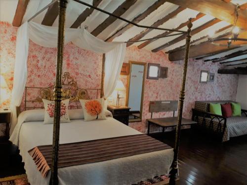 um quarto com uma cama de dossel num quarto em Los Colmenares em Cuzcurrita-Río Tirón