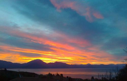 a sunset over a body of water with mountains at Casa Vacanze Baia Garagliano in Scario