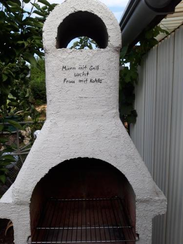 a stone oven with a sign on the top of it at Ferienapartment-Monteurwohnung-Muldestausee in Pouch