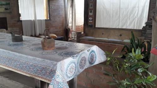 a table with a table cloth on it in a room at A Casinha Pequenina in Monte Verde