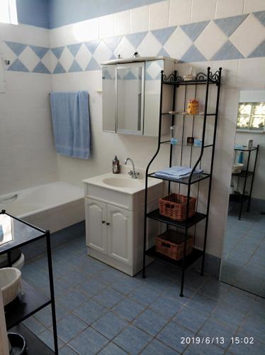a bathroom with a sink and a mirror and a tub at Villa AMIA in Áyios Spirídhon