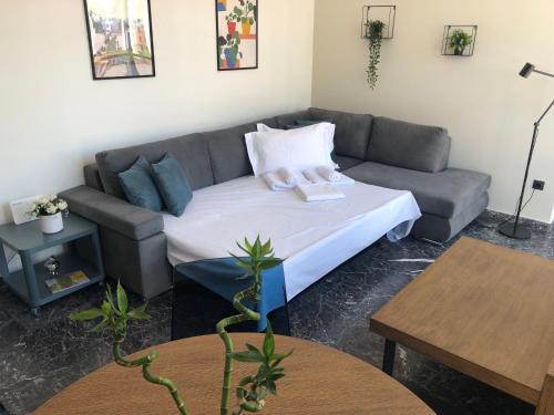 a living room with a couch and a table at Ladadika 5th Floor in Thessaloniki