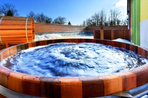 a circular hot tub with snow in it at Hotel Lesana in Vysoké Tatry