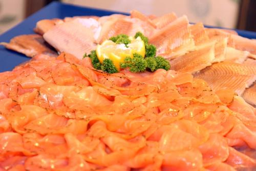 a pile of carrots and broccoli on a blue plate at Hotel-Berggasthof Schwarzwaldperle in Sasbachwalden