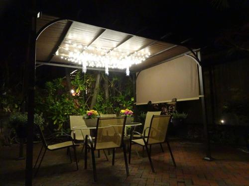 a table and chairs under a pavilion at night at Suite Dreams Inn by the Beach in Key West